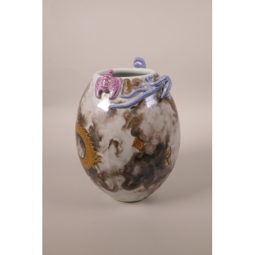 23 - A Chinese polychrome porcelain vase with applied dragon and bat decoration to the lip and red and gi... 