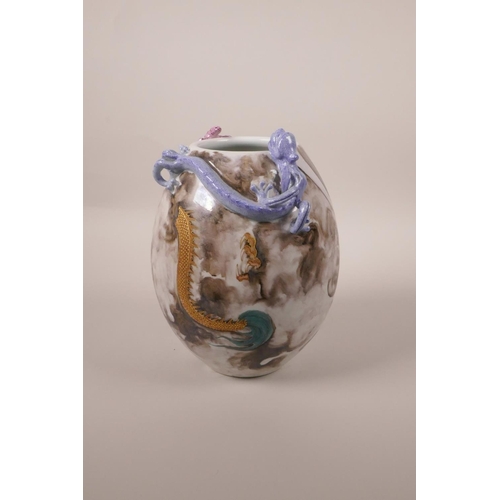 23 - A Chinese polychrome porcelain vase with applied dragon and bat decoration to the lip and red and gi... 