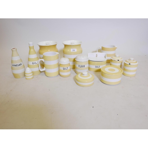 254 - A collection of fourteen pieces of T. and G. Green Cornish kitchen ware in yellow banded glaze, incl... 