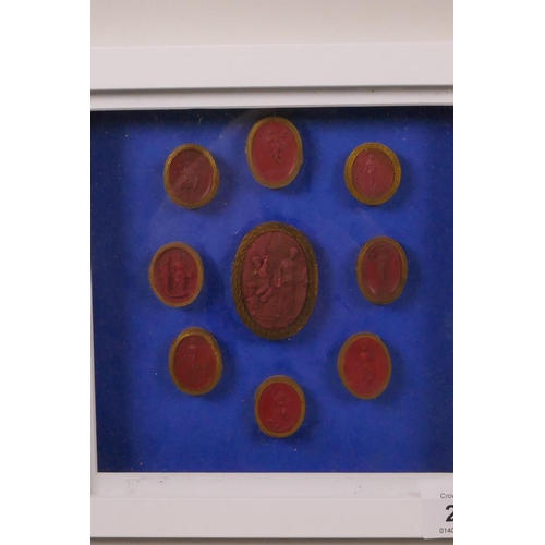 261 - A set of nine Italian C18th Grand Tour red wax intaglios, box mounted on a blue background, 8