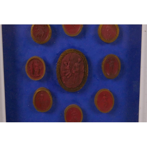 261 - A set of nine Italian C18th Grand Tour red wax intaglios, box mounted on a blue background, 8