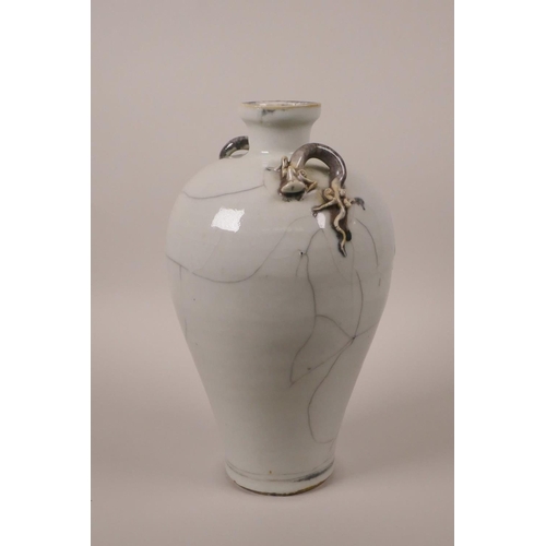 28 - A Chinese crackle glazed pottery vase with two dragon handles, 9½