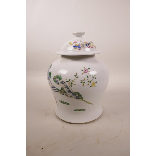 300 - A Chinese polychrome porcelain jar and cover decorated with women and children in a garden, 8½