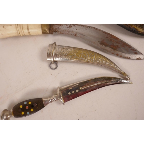 306 - Two Indian daggers, one with bone handle and ornate bejewelled scabbard, the other with engraved whi... 