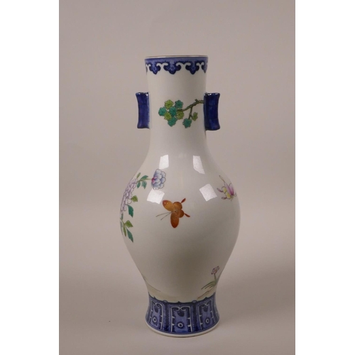 33 - A Chinese polychrome porcelain vase with two lug handles, decorated with Asiatic birds and butterfli... 