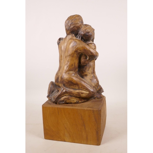 334 - A pottery sculpture of a lovers' embrace, on a wood plinth, 13½