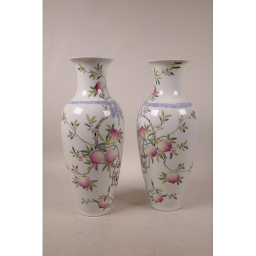 348 - A pair of Chinese polychrome porcelain vases with peach tree decoration, 6 character mark to base, A... 