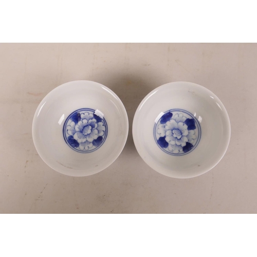 350 - A pair of Chinese blue and white porcelain footed bowls with floral decoration, 3½