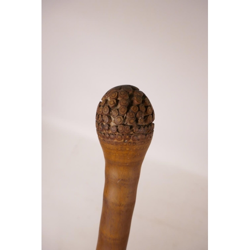 352 - A Chinese bamboo walking stick with carved monkey decoration, 34½