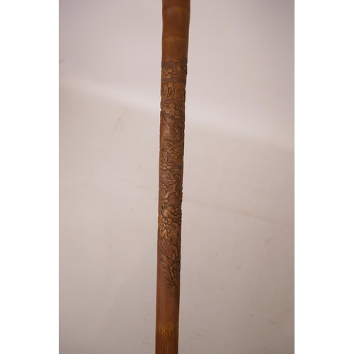 352 - A Chinese bamboo walking stick with carved monkey decoration, 34½