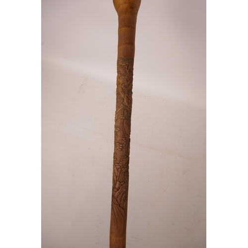 352 - A Chinese bamboo walking stick with carved monkey decoration, 34½