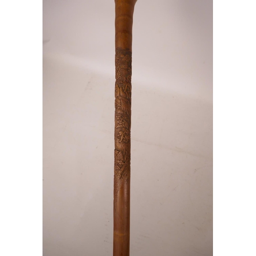 352 - A Chinese bamboo walking stick with carved monkey decoration, 34½