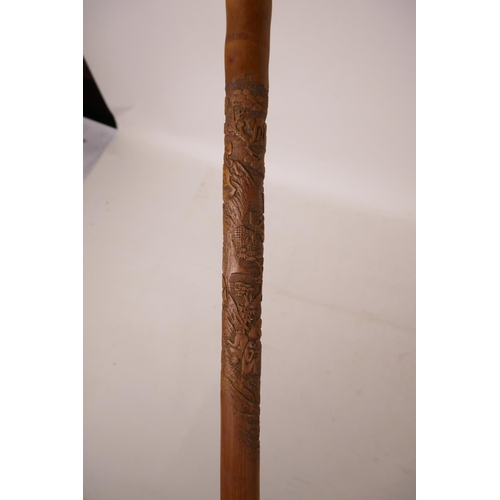 352 - A Chinese bamboo walking stick with carved monkey decoration, 34½