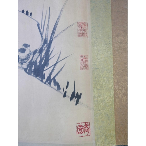 353 - A large Chinese watercolour scroll depicting birds amongst flowers, approximately 110