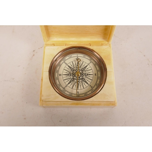 360 - A bone cased copper compass, the cover with engraved decoration of figures loading a cannon, 3