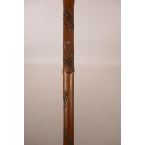 362 - A Chinese bamboo walking stick with carved snake decoration, 35½