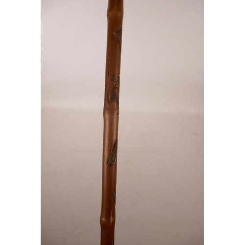 362 - A Chinese bamboo walking stick with carved snake decoration, 35½