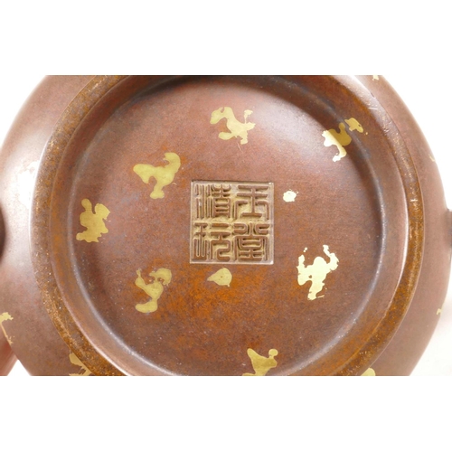 365 - A Chinese coppered bronze two handled censer on stand, with gilt splash decoration, impressed seal m... 