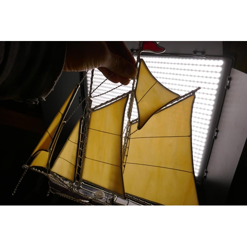 374 - A metal and glass model of a sailing boat, 13