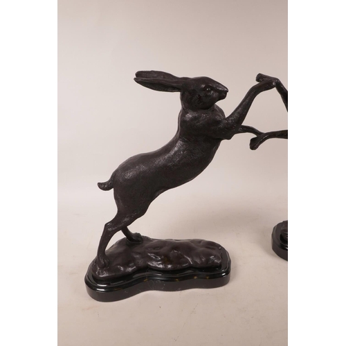 375 - A bronzed metal figure of boxing hares, 11½