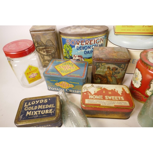 377 - A collection of vintage biscuit tins, bottle jars etc