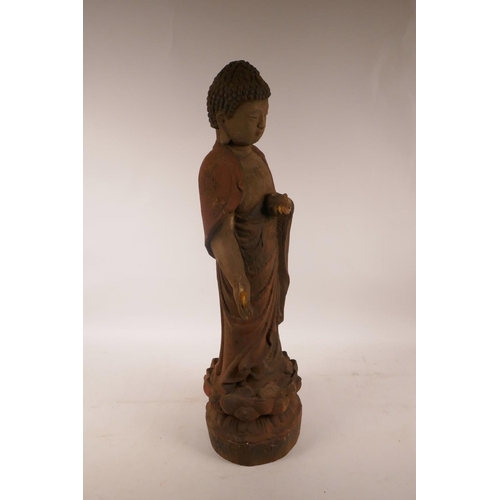 378 - A Chinese carved and painted wood figure of Buddha standing on a lotus flower, A/F minor losses, 22½... 