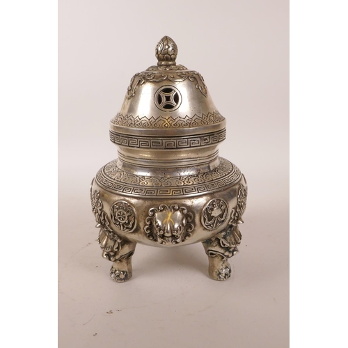 38 - A Chinese white metal censer and cover with three lion mask handles, raised on tripod supports, 4 ch... 