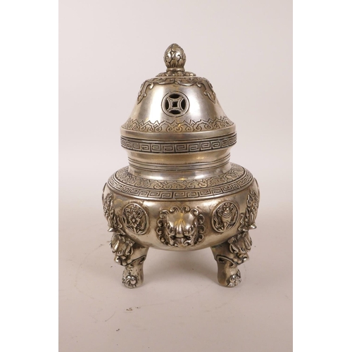 38 - A Chinese white metal censer and cover with three lion mask handles, raised on tripod supports, 4 ch... 