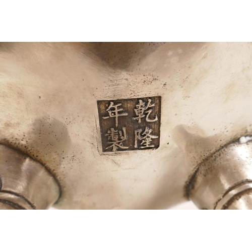 38 - A Chinese white metal censer and cover with three lion mask handles, raised on tripod supports, 4 ch... 