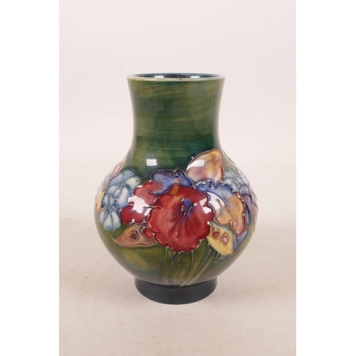 386 - A Moorcroft pottery green ground flower vase, 5