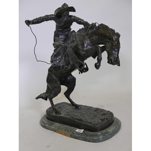 389 - After Frederic Remington, 'Bronco Buster', patinated bronze figure of a cowboy, impressed with signa... 