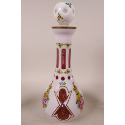 392 - A Bohemian white cased red glass liquer set of decanter and four glasses, painted with flowers in br... 