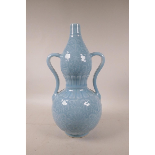 408 - A Chinese blue glazed porcelain double gourd vase with two handles and underglaze lotus flower decor... 