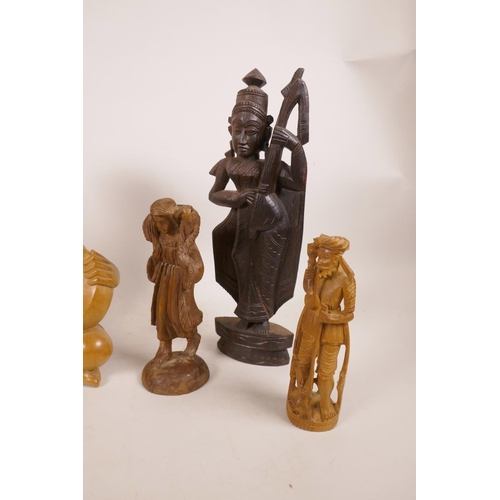 41 - Three Balinese carved wood figures of musicians, together with three other carved wood figures, 10