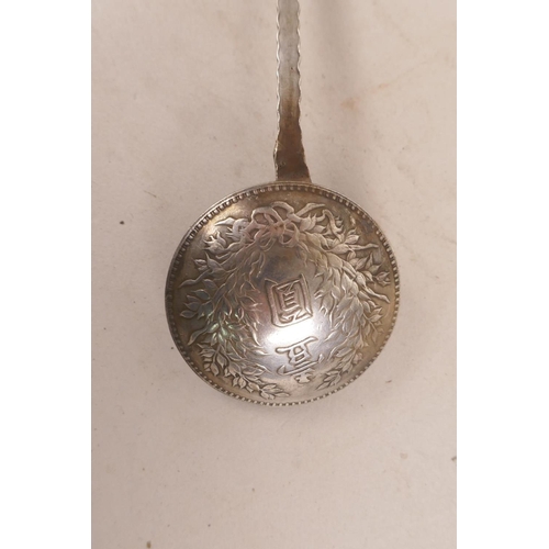 413 - A Chinese white metal coin spoon, 7