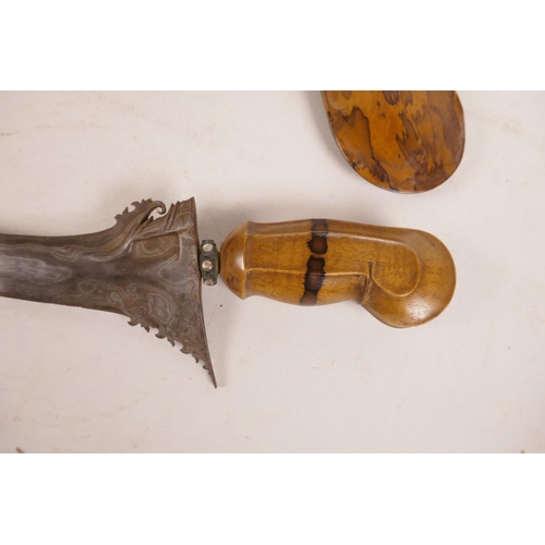 419 - An Indonesian kris dagger with a watered blade and splatted tamarind wood sheath and handle, 24