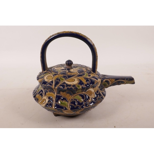 438 - A Japanese redware pottery teapot possibly by Kozan, with cursive blue and cream foliate decoration,... 