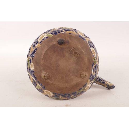 438 - A Japanese redware pottery teapot possibly by Kozan, with cursive blue and cream foliate decoration,... 