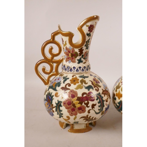 442 - A pair of Austrian porcelain ewers by Jos Steidl Znaim, with Zsolnay style decoration, A/F, 9½