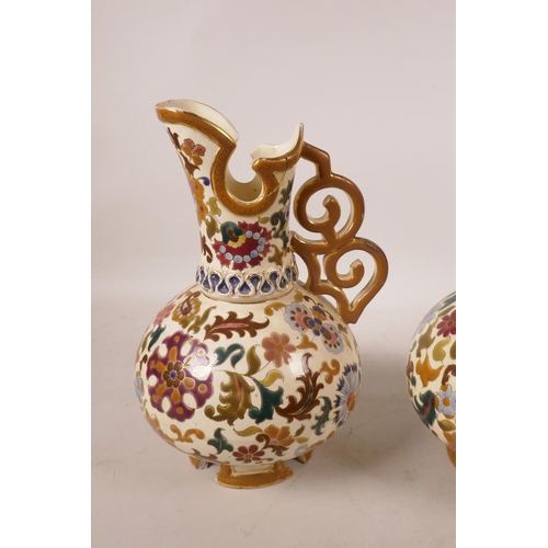 442 - A pair of Austrian porcelain ewers by Jos Steidl Znaim, with Zsolnay style decoration, A/F, 9½