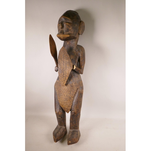 458 - An African carved wood figure of a warrior, 31