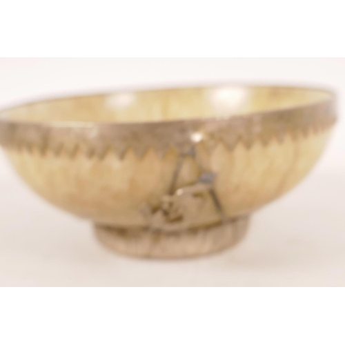 469 - A Chinese hardstone bowl with white metal mount decorated with dragons, 4¼