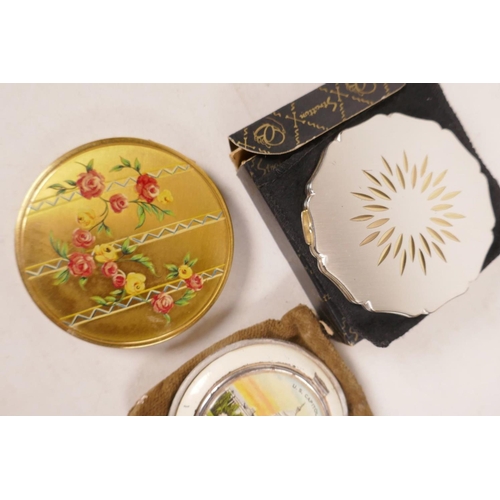 508 - Three vintage powder compacts, a Stratton Starburst brushed metal, an American one depicting the Cap... 