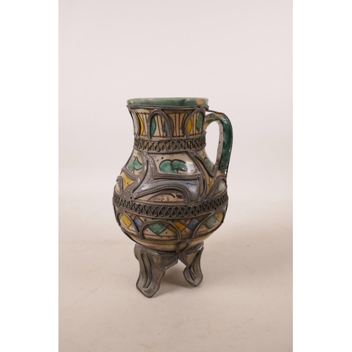 517 - A North African pottery ewer with metal mounts, A/F repair to rim, 7½