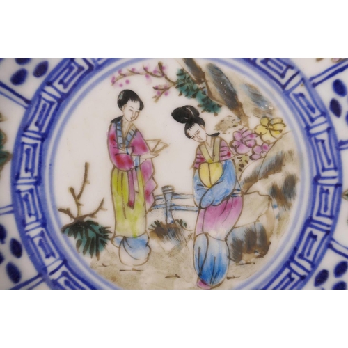 521 - An early C20th Japanese blue and white saucer with polychrome enamel decoration of two women in an o... 