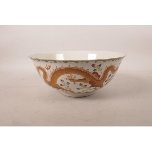 523 - A Chinese polychrome enamelled porcelain bowl decorated with two dragons chasing the flaming pearl, ... 