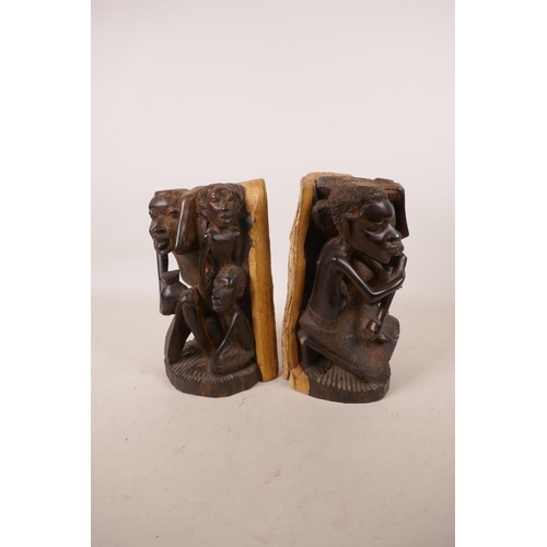 533 - A pair of lignum vitae African bookends with carved figural decoration, 8