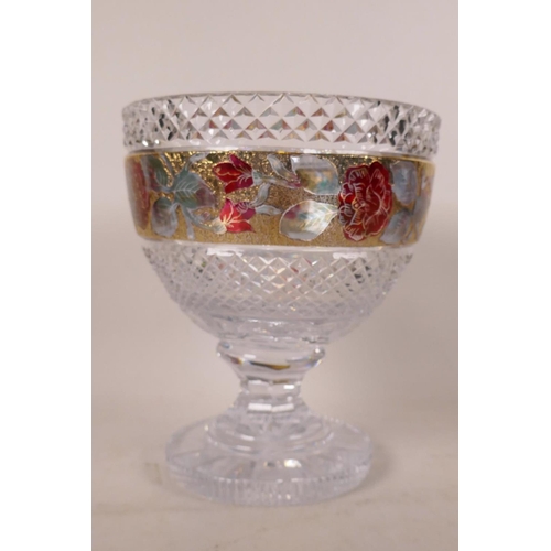 540 - A heavy lead crystal goblet shaped pedestal vase decorated with enamelled roses in a gilt band, 8