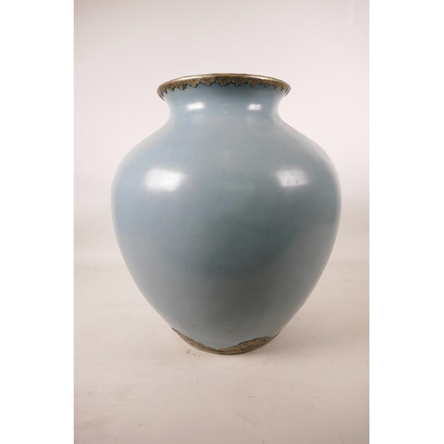 547 - A large Chinese duck egg blue glazed pottery jar with brass mounts, 13½