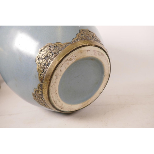 547 - A large Chinese duck egg blue glazed pottery jar with brass mounts, 13½